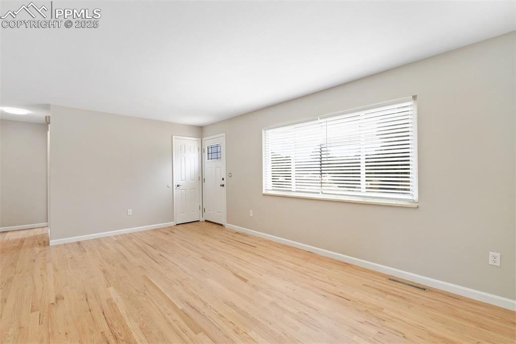 Image 32 of 50: New interior paint and refinished 2" oak flooring on main level.