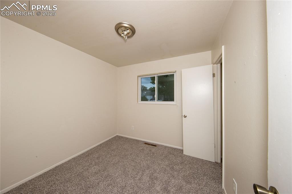 Image 15 of 21: Carpeted empty room with visible vents and baseboards