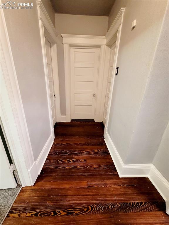 Image 14 of 21: Hallway featuring rich wood-finish flooring, crisp white baseboards, white 