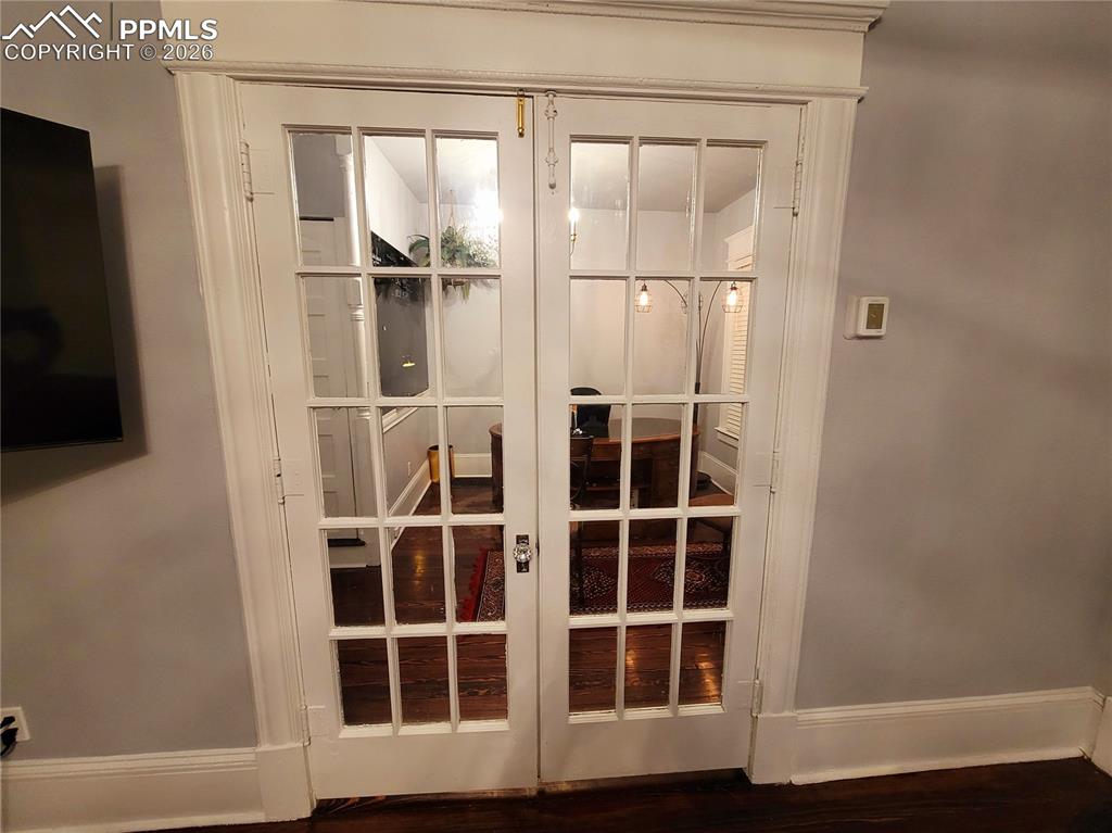 Image 6 of 21: French doors featuring multiple glass panes and white trim