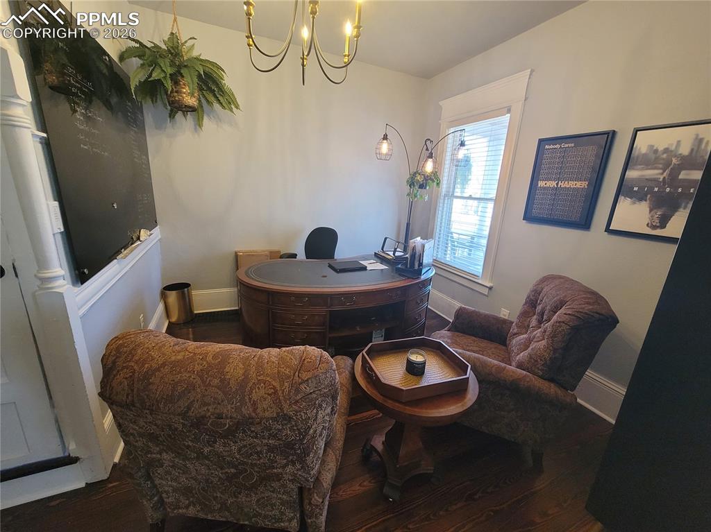Image 7 of 21: Hardwood-style flooring throughout this space with a large window featuring