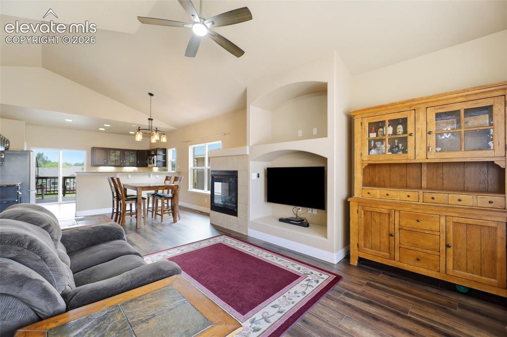 Image 4 of 36: Living room featuring a gas fireplace and built ins