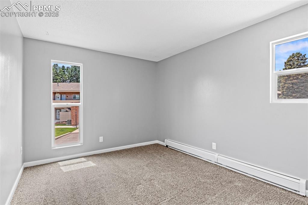 Image 19 of 44: Bedroom 1 of F5 portion of Condo with view of window