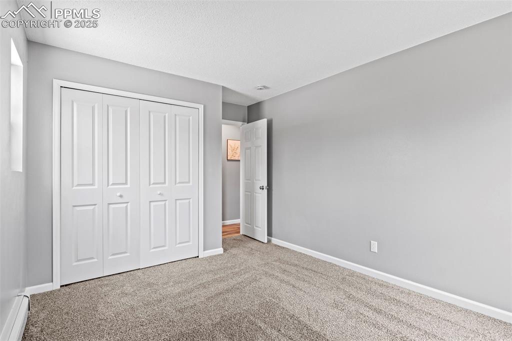 Image 20 of 44: Bedroom 1 of F5 portion of Condo with view of door