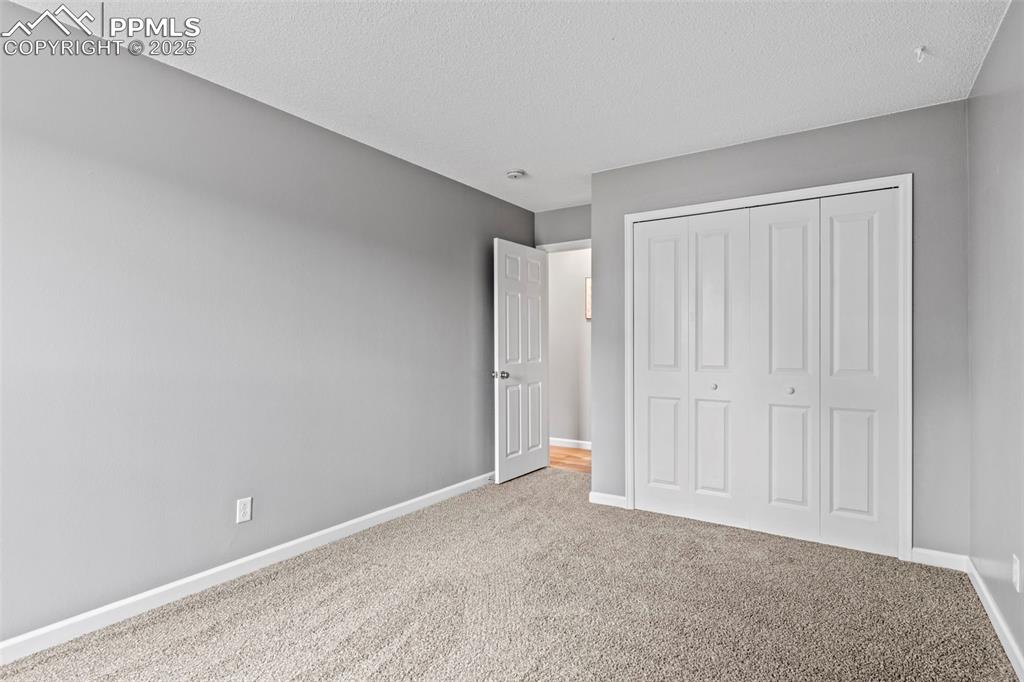 Image 22 of 44: Bedroom 2 of F5 portion of Condo with view of Door