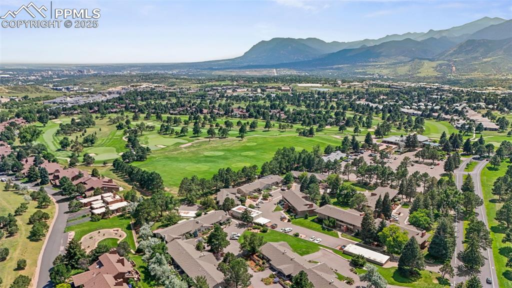 Image 38 of 44: Aerial view of property and surrounding area with a golf course, nearby sub