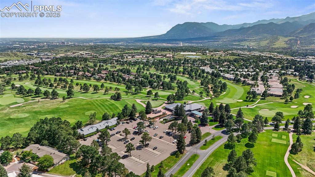 Image 40 of 44: Aerial perspective of suburban area featuring a golf club and mountains