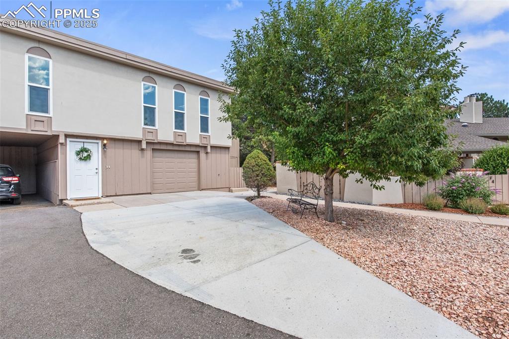 Image 5 of 44: View of front of property featuring driveway, a garage, and stucco siding