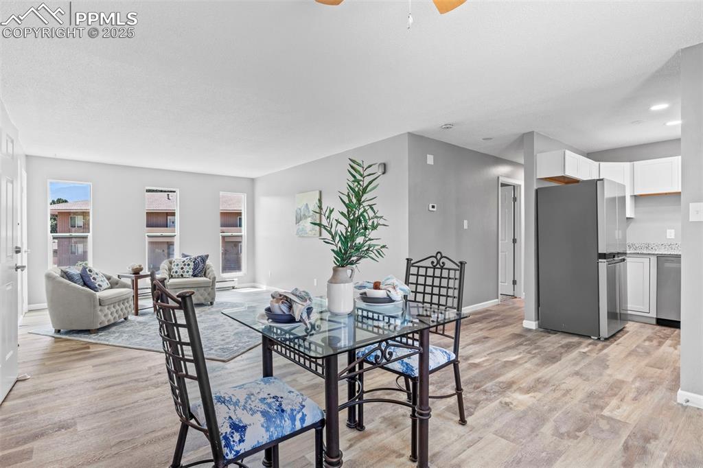 Image 9 of 44: Dining room featuring ceiling fan and light wood finished floors