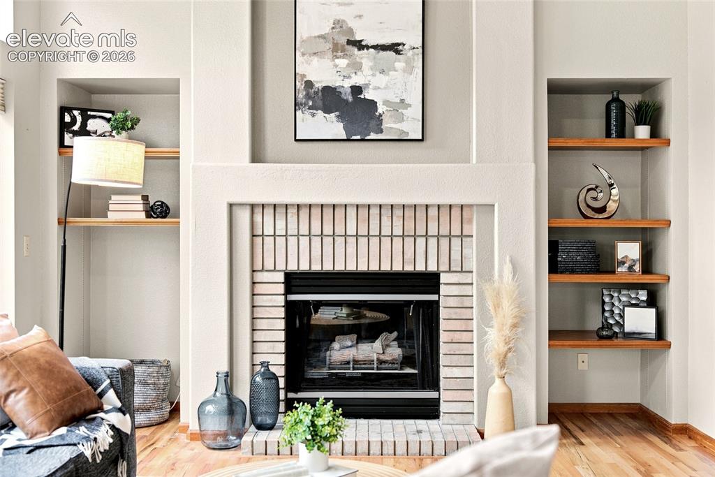 Image 3 of 27: Living Room with Built-Ins and Fireplace