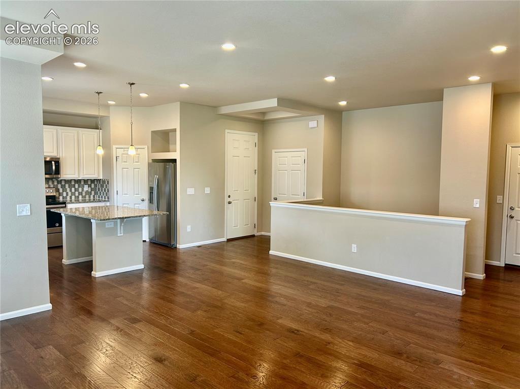 Image 12 of 38: Dining area next to the half wall