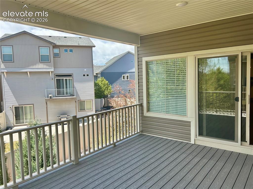 Image 2 of 38: Spacious covered deck overlooking side and backyard.
