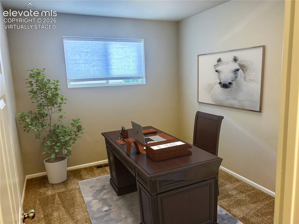 Image 21 of 38: Main level office/flex space virtually staged