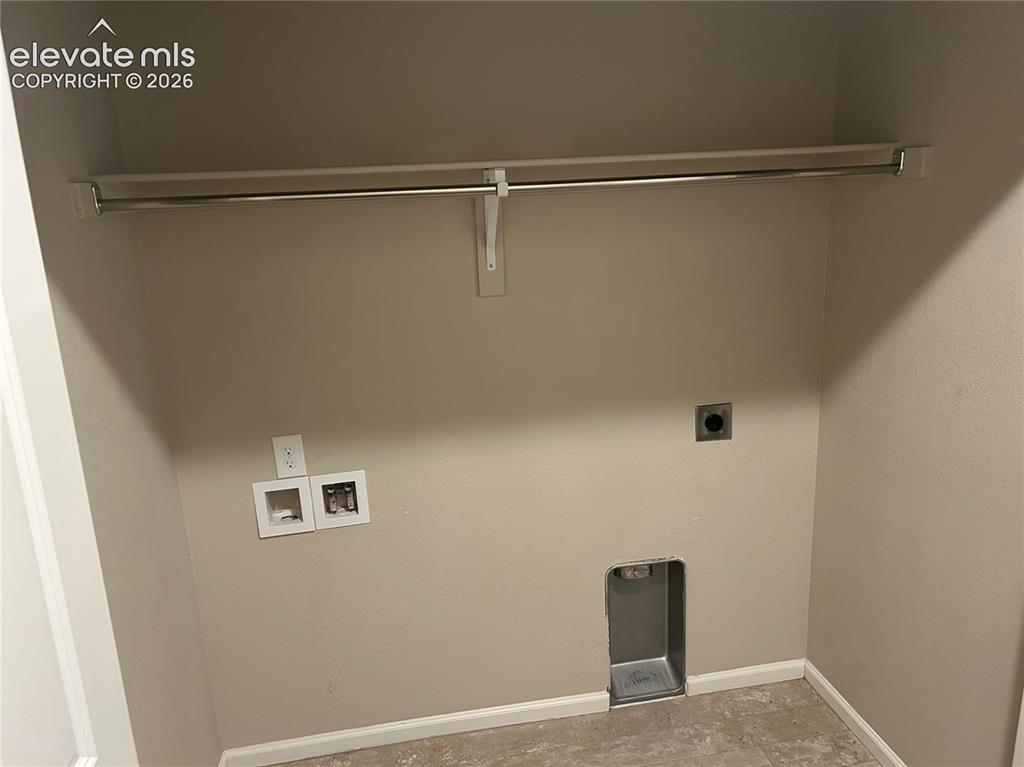 Image 24 of 38: laundry space located in the hallway between the primary bedroom and flex r