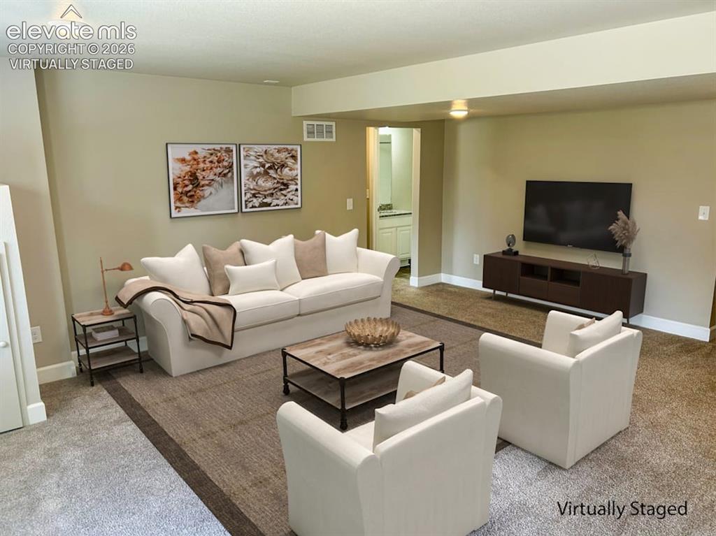 Image 25 of 38: Basement living space virtually staged