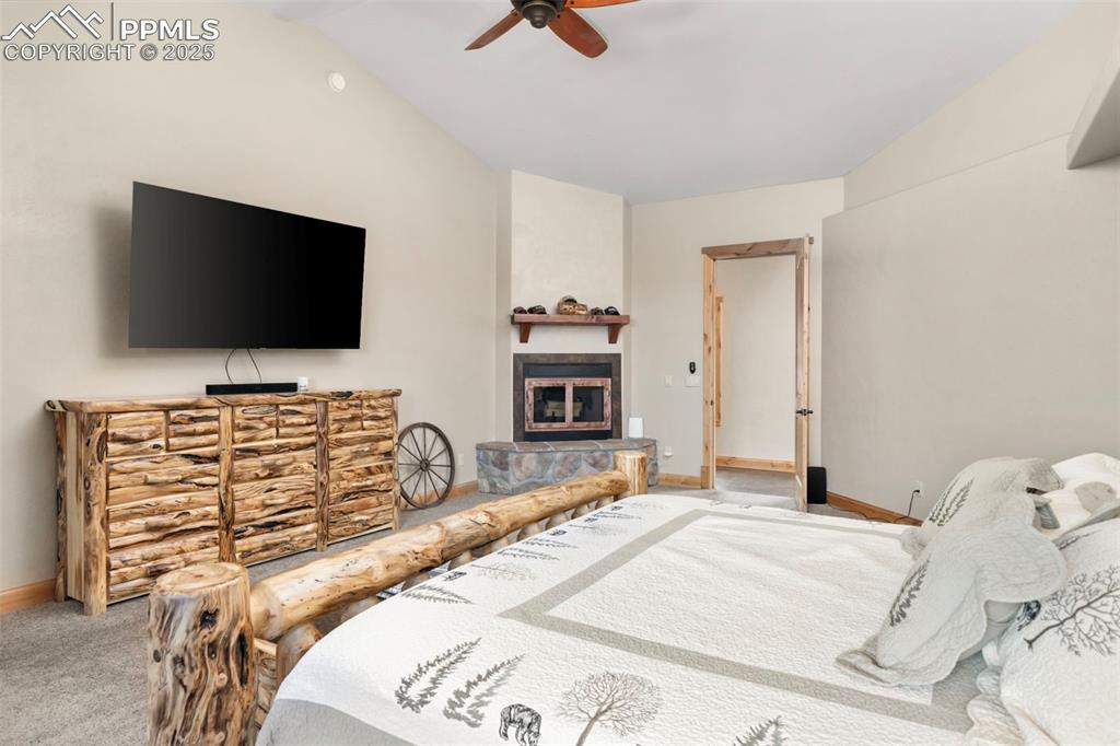 Image 21 of 47: Primary Bedroom with Woodburning Fireplace