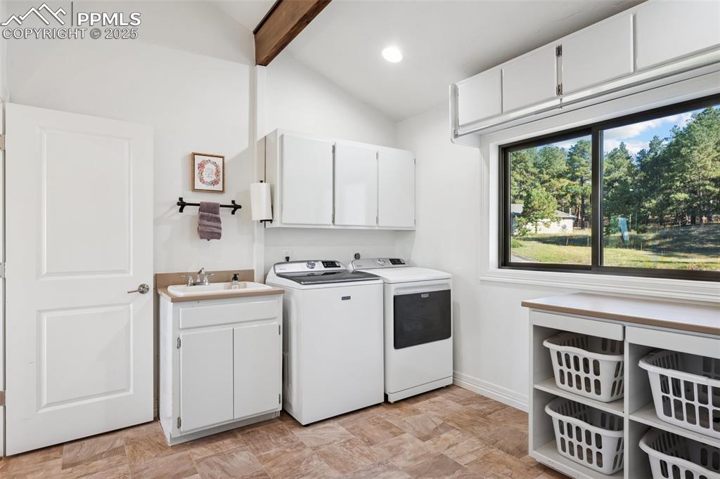 Image 10 of 49: Washroom with cabinet space, washer and clothes dryer, and recessed lightin