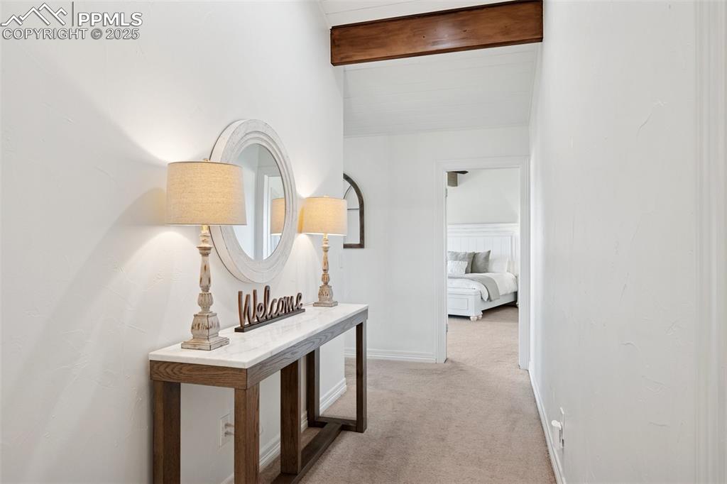 Image 14 of 49: Corridor featuring light carpet and baseboards