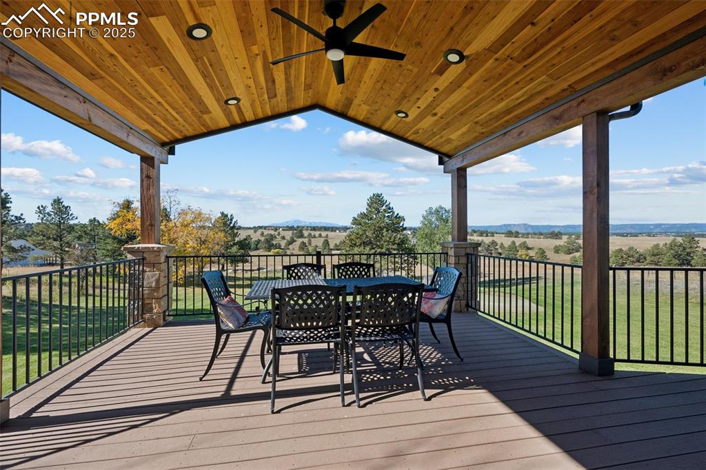 Image 2 of 49: Deck featuring tongue and groove ceiling, fan, outdoor dining space, and a 