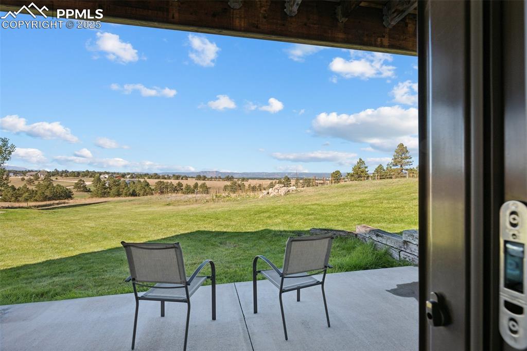 Image 32 of 49: View of patio with a rural view