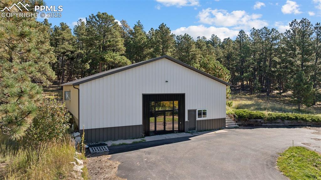 Image 35 of 49: 3 Structure - multi-use office space, storage space, large garage door coul