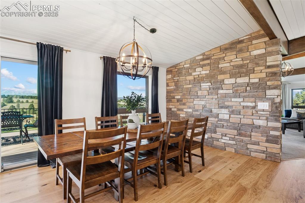 Image 5 of 49: Dining space featuring light wood-style flooring, a chandelier, and wooden 