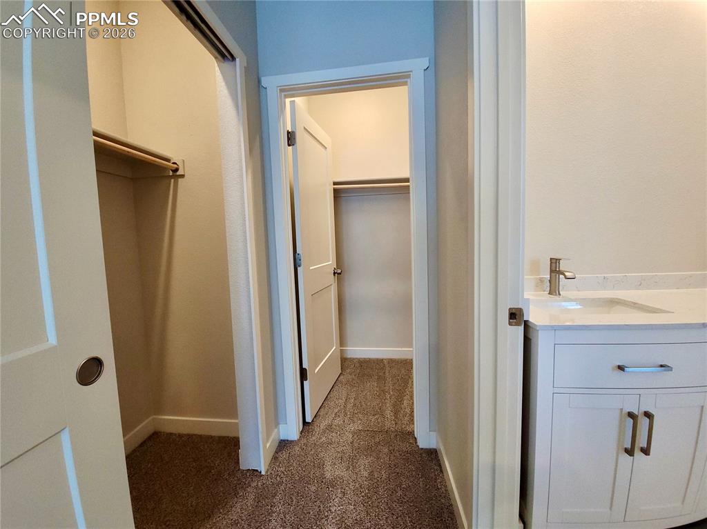 Image 18 of 47: Primary suite offers a walk-in closet, secondary closet, and attached bathr