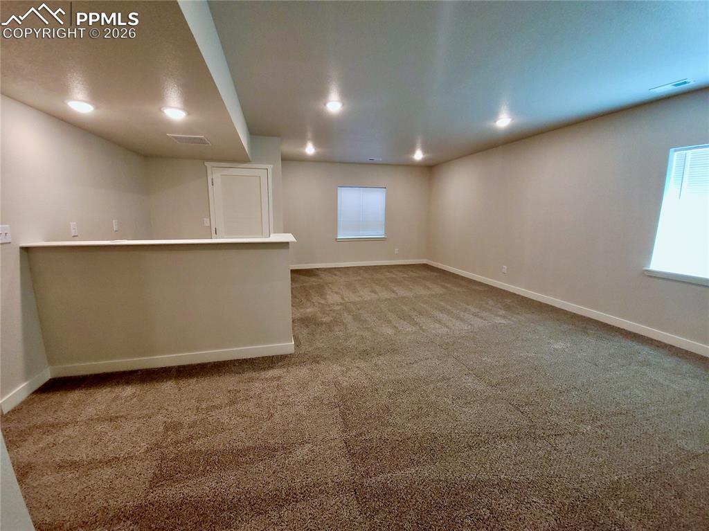 Image 30 of 47: Large basement rec room with pre-plumbed wet bar (example finishes)