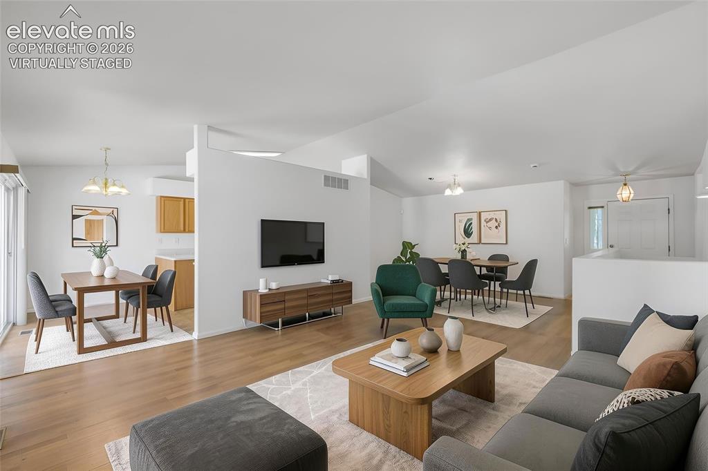 Image 13 of 45: Open-concept living area virtually staged