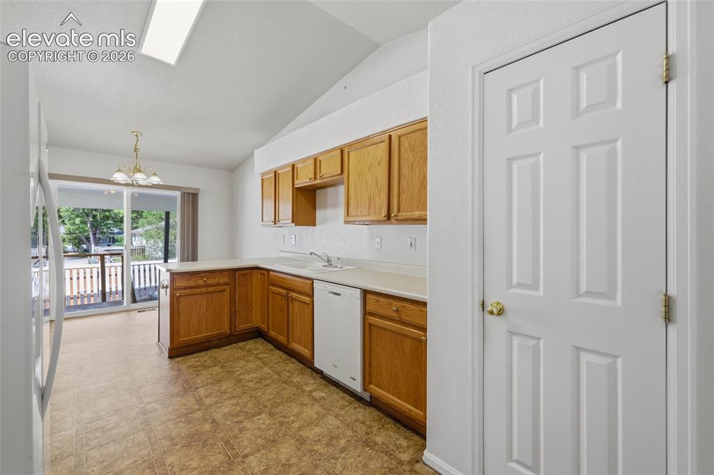 Image 18 of 45: Kitchen featuring wood cabinetry, solid surface countertops, and an integra