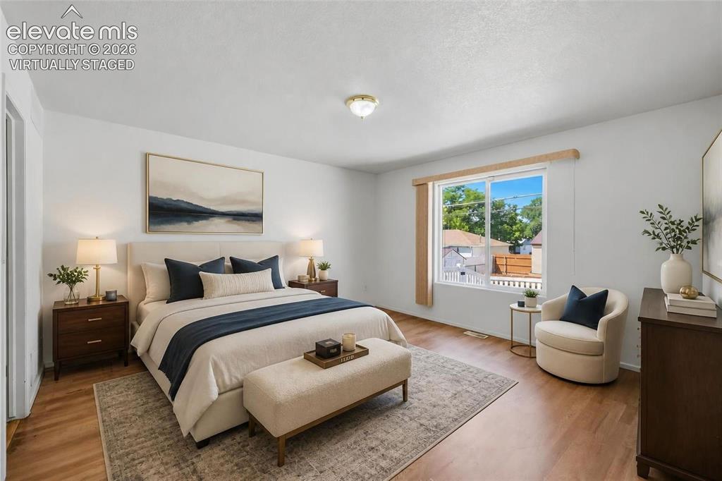 Image 22 of 45: Primary bedroom, virtually staged