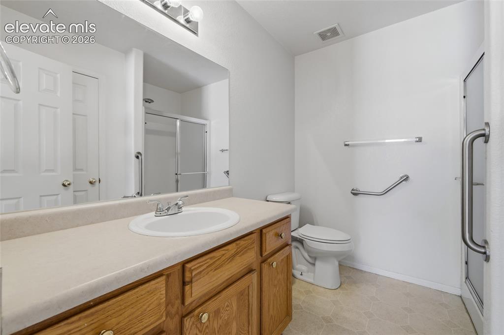 Image 24 of 45: Wood-finish vanity with an integrated sink and laminate countertop