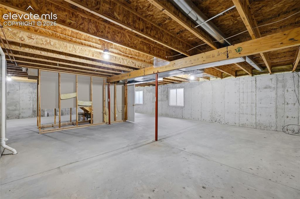 Image 34 of 45: Expansive unfinished lower level with concrete flooring, exposed ceiling jo