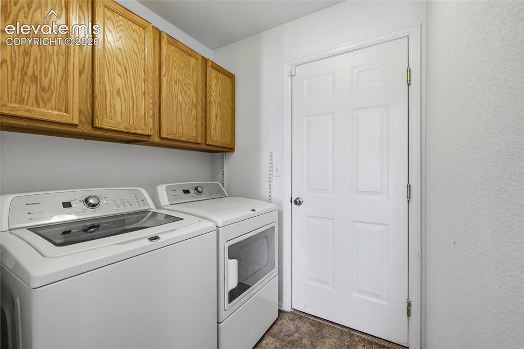 Image 35 of 45: Wood-finish cabinetry providing ample storage