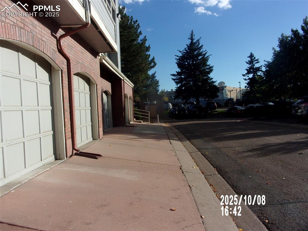 Image 13 of 13: View of asphalt road with curbs and sidewalks