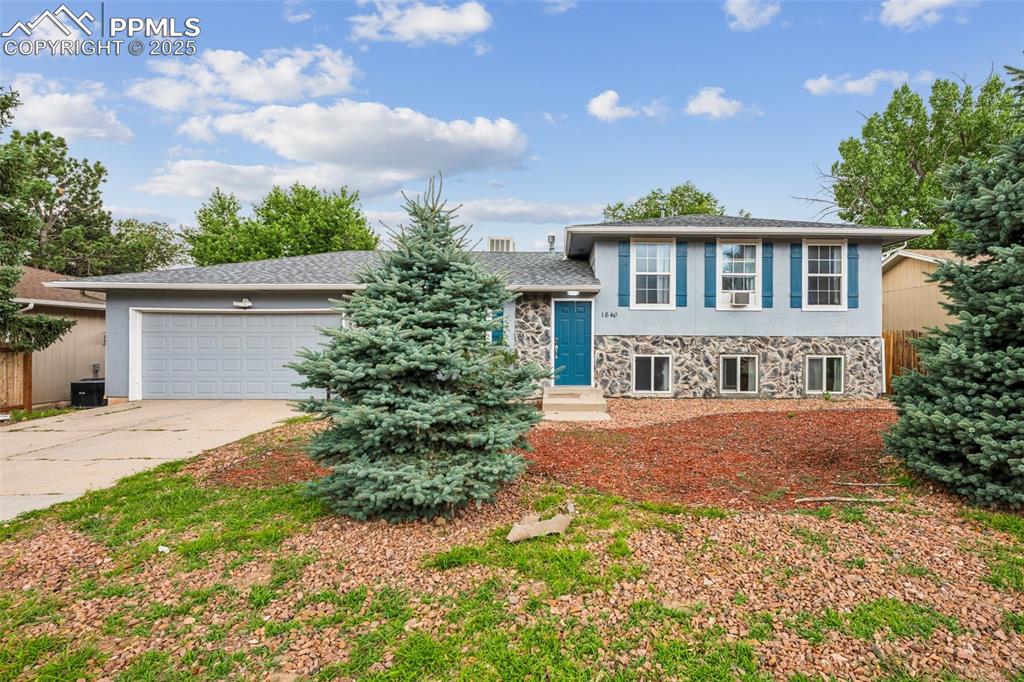 Caption: Updated tri-level with mature trees, and a welcoming front entry.