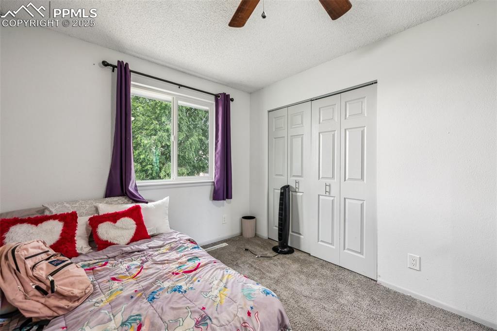 Image 15 of 19: Second angle of upper-level Bedroom 2 with newer carpet, large closet, and 