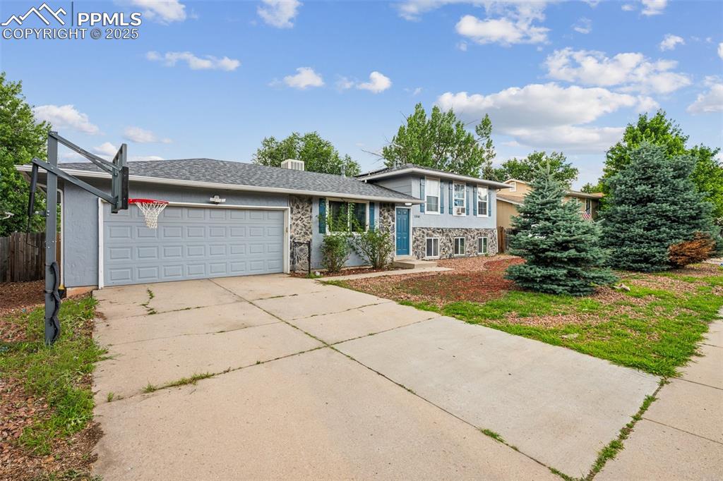 Image 2 of 19: Extended driveway and two-car garage with ample parking.
