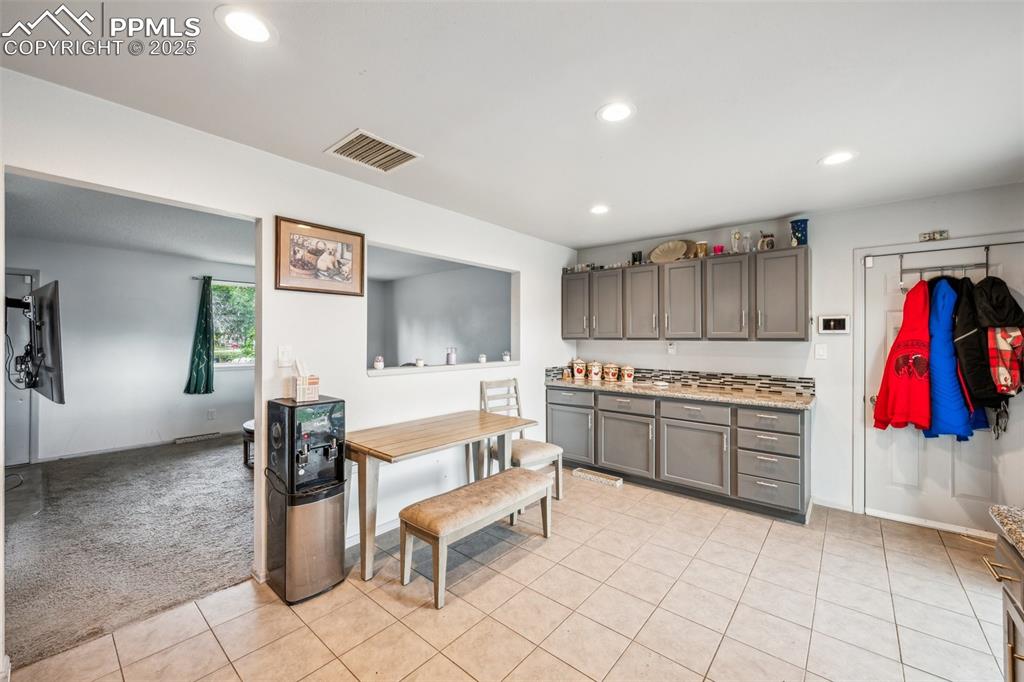 Image 7 of 19: Bright open-concept kitchen flows seamlessly into the living room, featurin