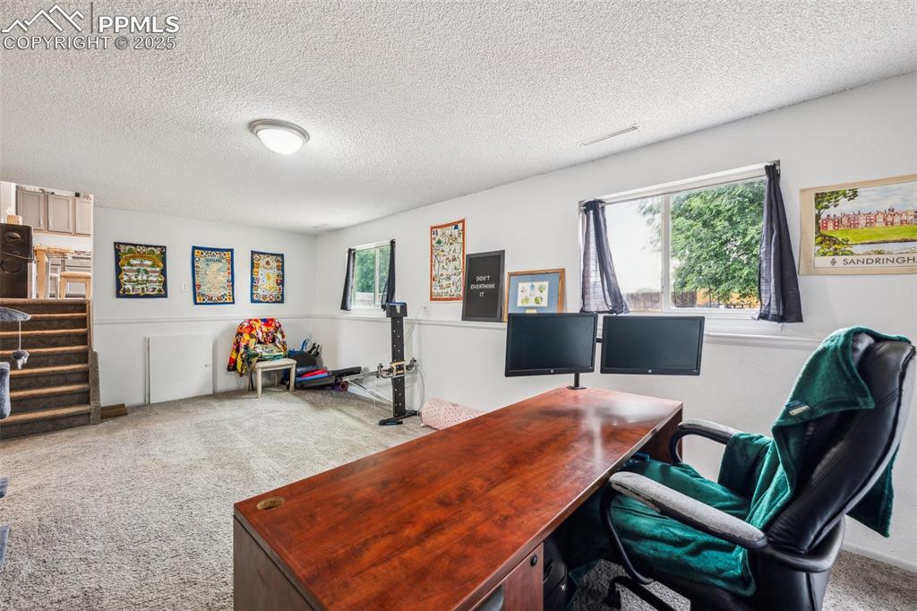 Image 8 of 19: Lower-level office or flex space — ideal for work-from-home or a gaming set