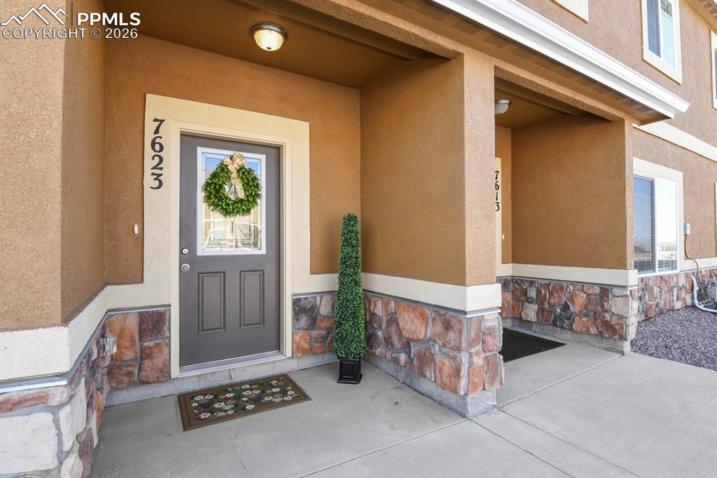 Image 1 of 27: The property features an exterior with stucco and natural stone accents, a 