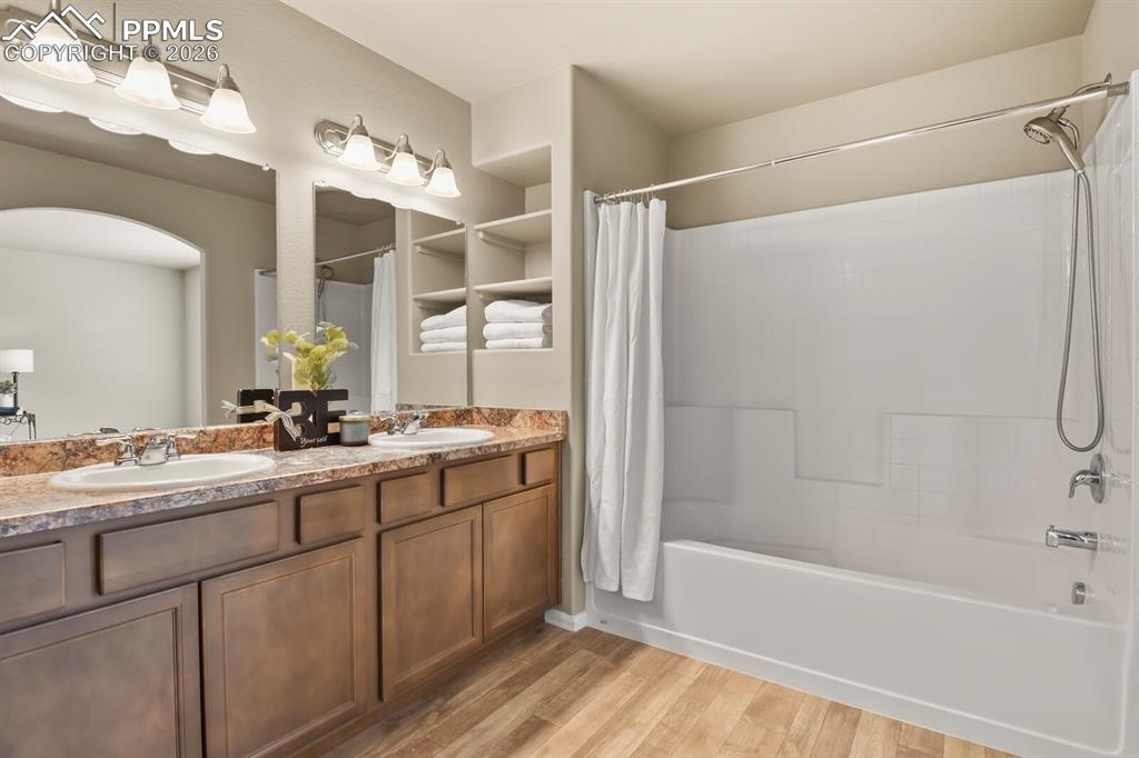 Image 17 of 27: Bathroom featuring a double vanity with ample counter space, a large mirror