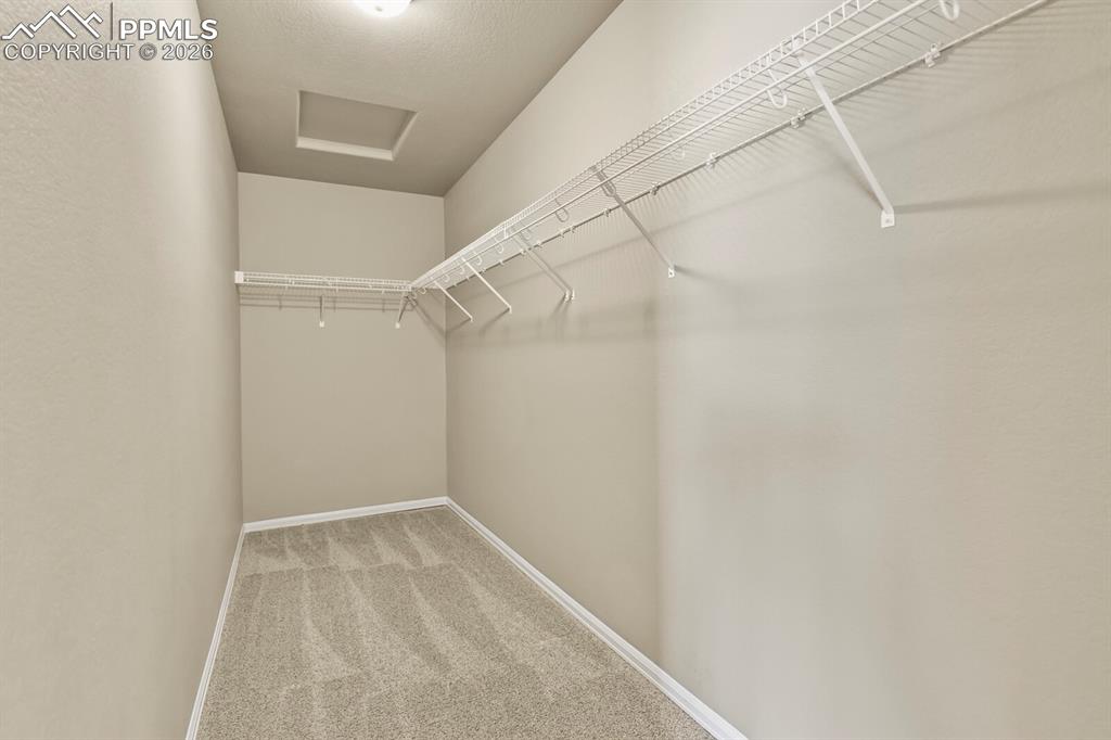 Image 19 of 27: The property features an interior room with light-colored walls, carpeted f