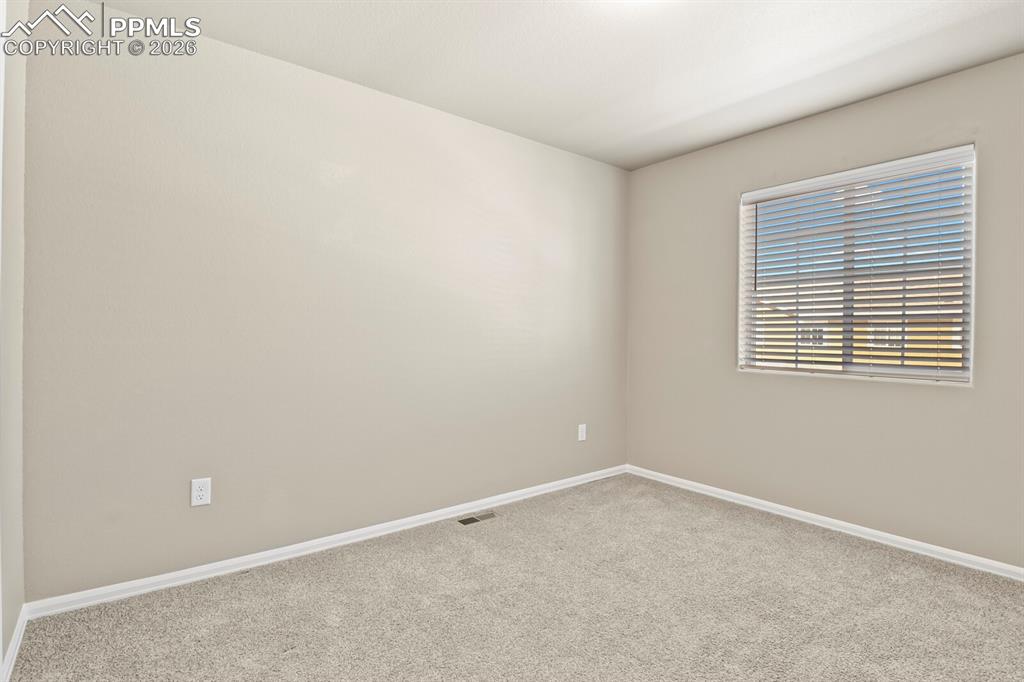 Image 24 of 27: This room offers light-colored walls, carpeting, and a window with blinds