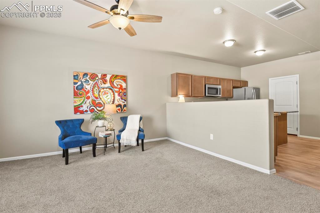 Image 4 of 27: This room features a ceiling fan, recessed lighting, and carpeted flooring