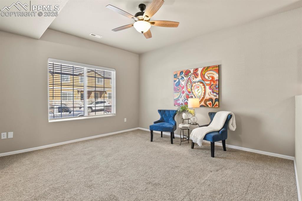 Image 5 of 27: Spacious room featuring carpeting, a ceiling fan with integrated lighting, 