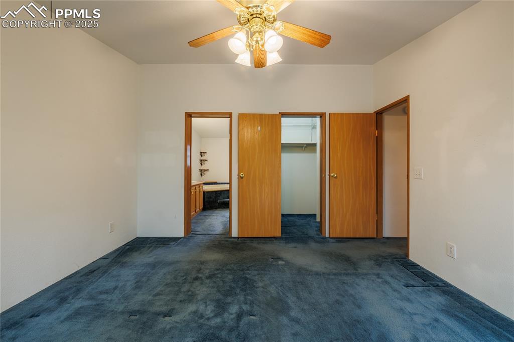 Image 13 of 26: Primary bedroom with carpet floors, a spacious closet, 
