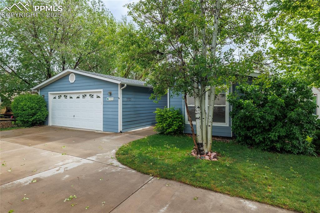 Image 2 of 26: View of front of house featuring an attached garage and a front lawn