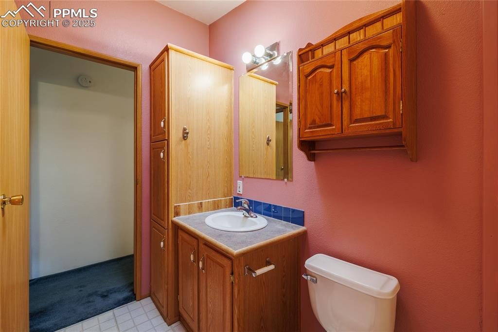 Image 22 of 26: Bathroom featuring vanity, toilet, and tile patterned floors