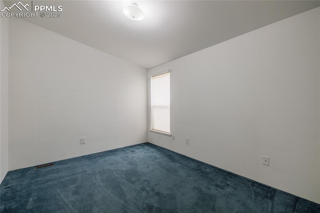 Image 23 of 26: Spare room featuring carpet